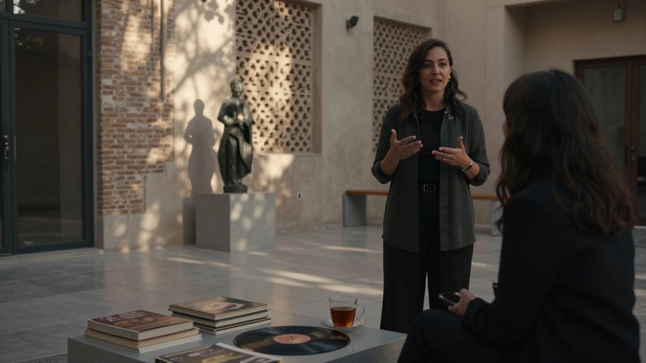 A woman stands in an art-filled Dubai courtyard, sunlight casting delicate shadows on the walls.