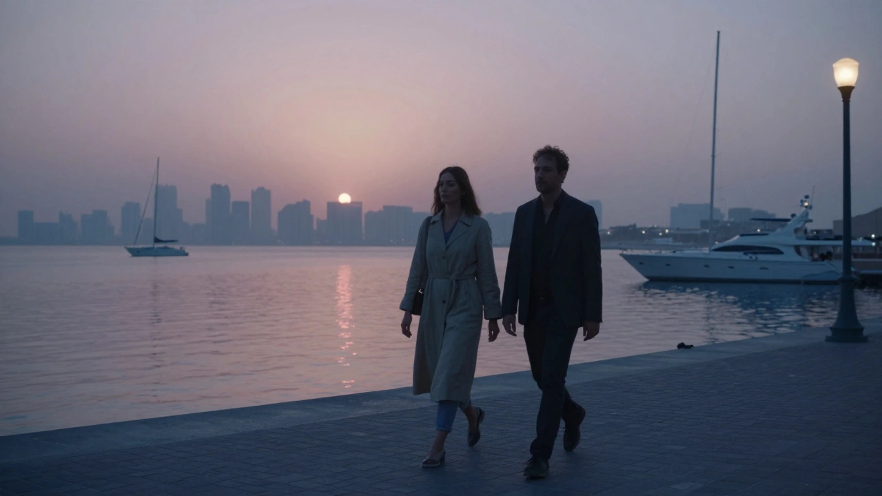 Two figures walk peacefully along Dubai Marina at sunrise, the skyline reflecting in calm water.